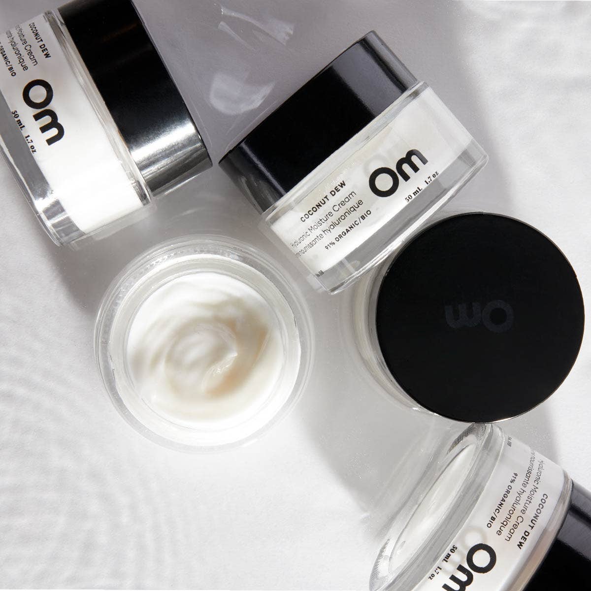 Jars of Coconut Dew Hyaluronic Moisture Cream with Om branding 